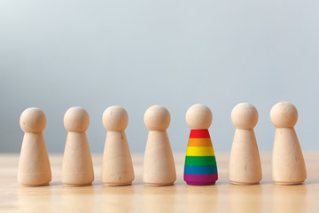 Human rights of LGBT campaign concept. Wooden dolls with rainbow colors are different stand out...
