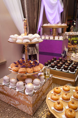 Banquet table with different food snacks, appetizers and dessetrs on corporate christmas birthday party event or wedding celebration