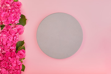Beautiful floral background and green leaves, texture, wallpaper. Flat-lay of pink hydrangea on rose background, top view, copy space greeting card