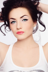 Young beautiful woman with dark hair and cat eye make-up