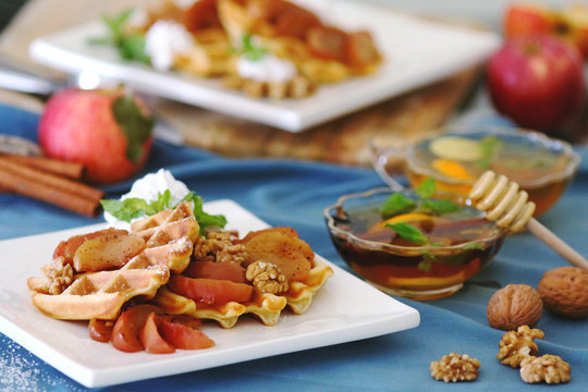 waffles sered with walnuts, honey and baked aples