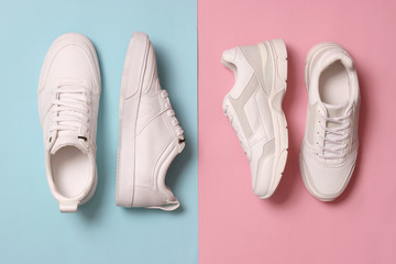  Men's and women's sneakers on a colored background top view. Sport shoes. White running shoes