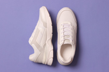 women's sneakers on a colored background top view. Women's shoes.