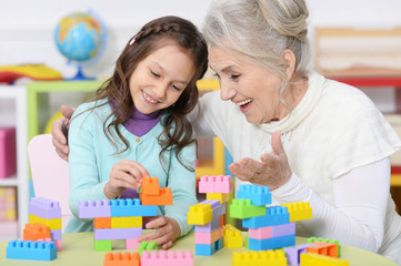 Portrait of cute girl and grandmother playing