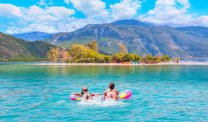 Girls in bikini lying on air bed in the turqouise sea - Oludeniz Beach And Blue Lagoon, Best...