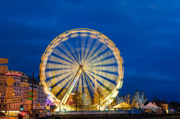 Long exposure shooting ferris wheel with the blue sky