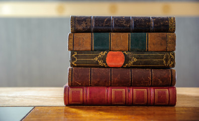Old vintage books on the wooden bookshelf