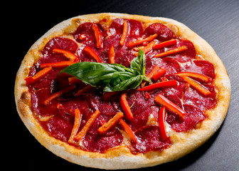 fresh italian pizza on black background