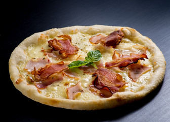 fresh italian pizza on black background