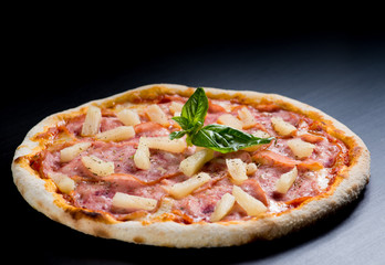 fresh italian pizza on black background