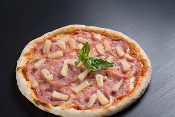 fresh italian pizza on black background