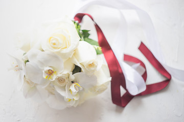 Wedding bouquet with white roses and orchids