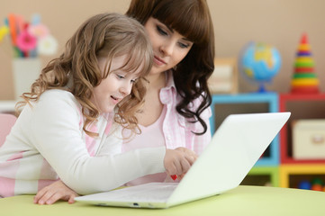 Portrait of cute girl using laptop at home