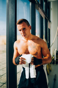 Portrait of boxer preparing to fight holding boxing glove