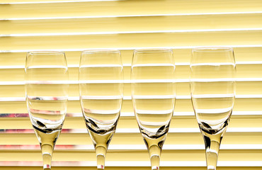 Glass glasses on the background of curtain blinds