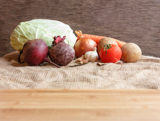 Raw vegetables for beet soup borsch. White cabbage, beet, carrot, potato, tomato, garlic on a...