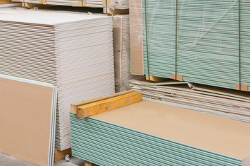 Gypsum plasterboard in the pack. The stack of gypsum board preparing for construction. Pallet with plasterboard in the building store. Construction Materials. Drywall warehouse