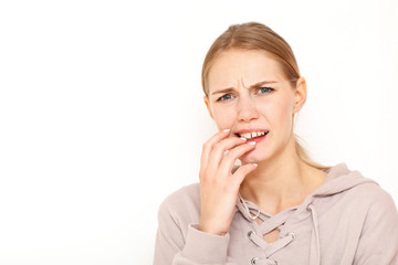 Fototapeta premium Image of European female with clueless expressions, doubts what to eat delicious for supper, isolated over white background. What to choose?