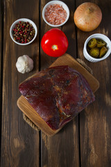 italian speck on wooden surface