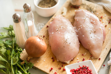 chicken fillet on a cutting Board with spices, chicken meat