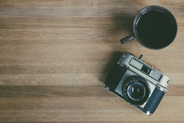 Photographers vintage, 35mm camera flat lay desk with coffee