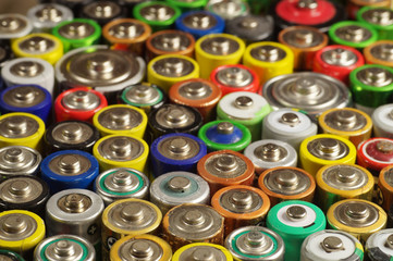 Dozens of types, sizes, colors of used batteries and accumulators. Recycling.