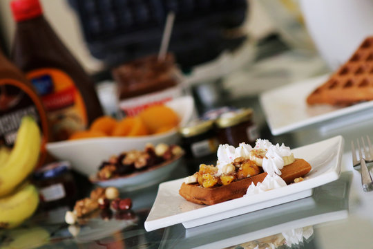 waffles sered with walnuts, honey and baked aples