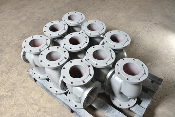 Gray metal pipes, bases for making valves, lie on a wooden panel before further processing on a milling machine. Base for creating valves in a factory
