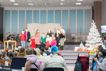 Performance for children on stage. Children on stage perform in front of parents. image of blur kid 's show on stage at school , for background usage. blurry