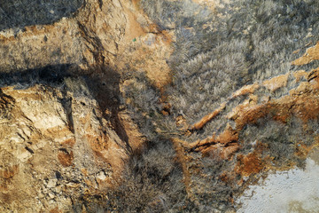 Landslide zone on Black Sea coast. Rock of sea rock shell. Zone of natural disasters during rainy season. Large masses of earth slip along slope of hill, destroy houses. Landslide - threat to life