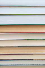 Stack of books background. many books piles. Many Books Piles. Books with color covers. Back to school. vertical photo