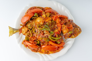 Sweet sour fried fish on white background with selective focus and crop fragment