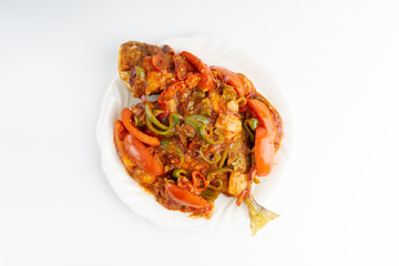 Sweet sour fried fish on white background with selective focus and crop fragment