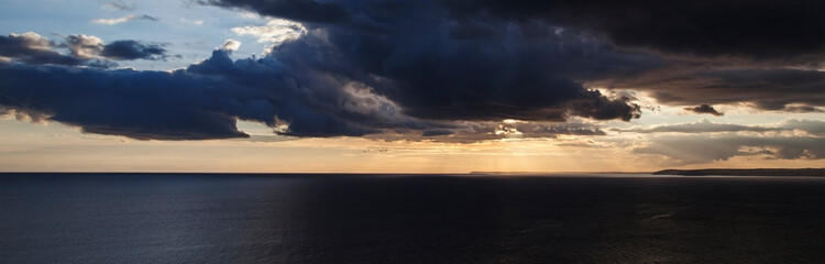 Sunset over the sea with amazing, inspirational skyscape - ocean panorama / header / banner.