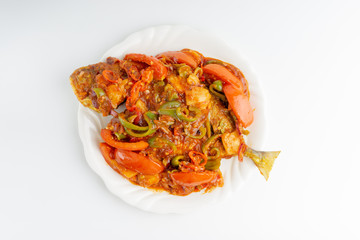 Sweet sour fried fish on white background with selective focus and crop fragment