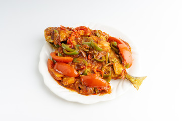 Sweet sour fried fish on white background with selective focus and crop fragment