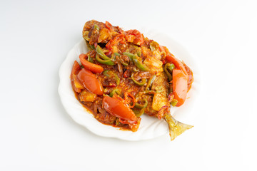 Sweet sour fried fish on white background with selective focus and crop fragment