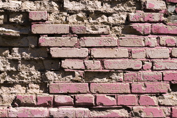 Crumbling painted pink brick wall texture