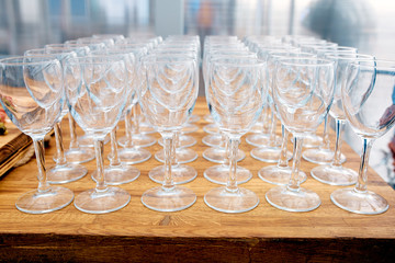 A lot of empty wine glasses on a wooden table
