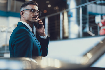 Attractive man speaking on telephone with boss