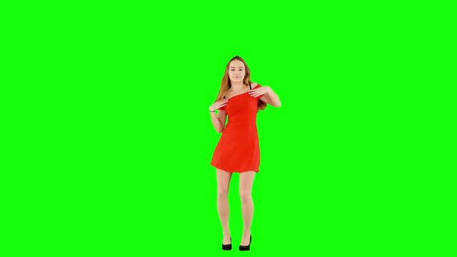 Attractive Girl in Red Dress Looking at the Camera and Dancing Green Screen