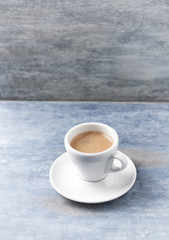 Cup of coffee on rustic wooden background. Copy space.