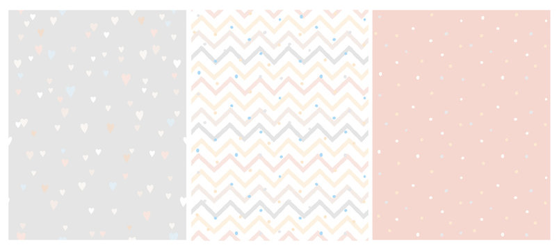 Set of 3 Bright Delicate Chevron, Hearts and Dots Vector Patterns. Irregular Tiny Dots Pattern. Hand Drawn Chevron Designs. White, Gray, Beige and Pink Pastel Design. Cute Nursery Art Patterns.