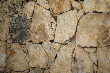 Stone wall of warm tones background