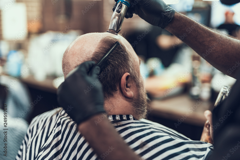 Wall mural Barber making hair cutting  on client head