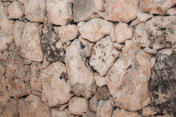 Stone wall of warm tones background
