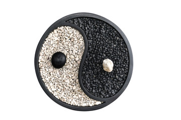 Yin and Yang Symbol made of white and black stones,