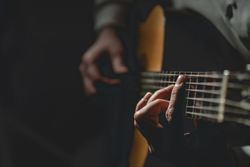 Close up on midsection of man Playing a guitar 
