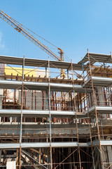 Scaffolds and cranes in a construction site