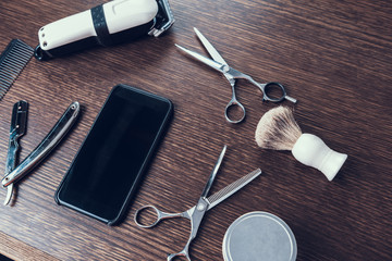 Close up photo of telephone and hair cutting equipment
